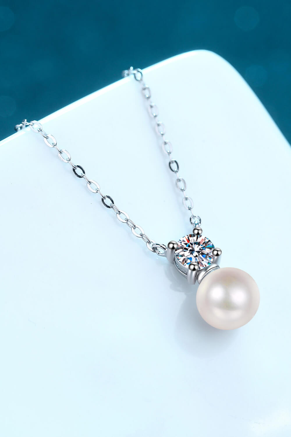 half carat moissanite and freshwater pearl rhodium plated sterling silver drop necklace