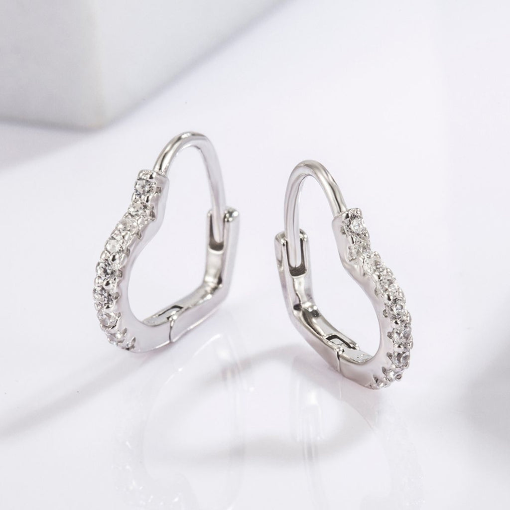 platinum plated heart shaped earrings lined with natural zircon gemstones